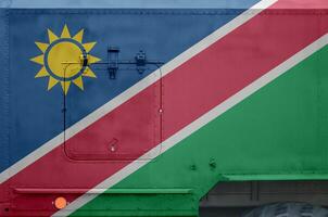 Namibia flag depicted on side part of military armored truck closeup. Army forces conceptual background photo