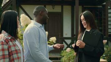 Asian female real estate agent sells house to African husband and Caucasian wife and hands over the keys.Multiracial Family,Mixed Race,Diverse People,Multiethnic Relations video