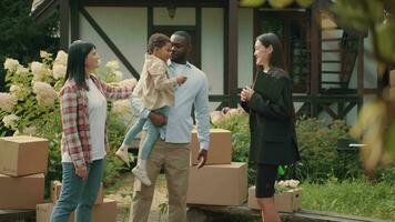 Asian female real estate agent selling a house to a multiethnic family. African dad, Caucasian mom, african child.Multiracial Family,Mixed Race,Diverse People,Multiethnic Relations video