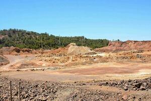 a large open pit with rocks and dirt photo