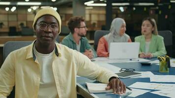 Portrait of a creative african american businessman sitting at a table in the office. Team leader.Different Races,Diverse People,Creative Team,Business Partners video