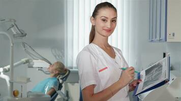 Female dentist poses at the dental clinic video