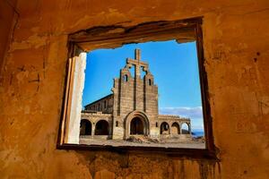 an old building with a window in it photo