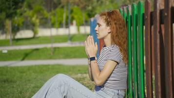 Christian young woman's prayer on the ground. video