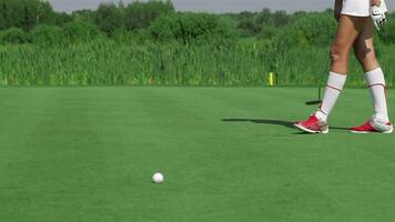 Woman kneels at the golf video