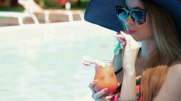 Woman drink cocktail near the swimming pool video