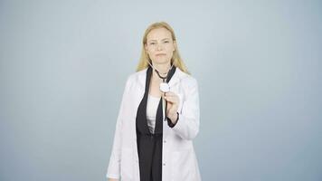 Doctor listening to camera with stethoscope. video