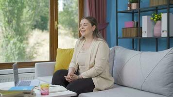 Happy and peaceful woman. She is sitting in front of the window. video