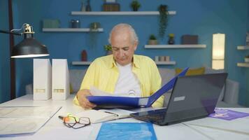 Home office worker man smiling at camera looking at paperwork. video