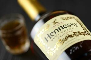 KYIV, UKRAINE - MAY 4, 2022 Hennessy Very Special original alcohol bottle on black wooden table photo