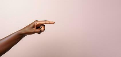 A womans hand pointing to the top in front of a pastel colored background. AI generative photo