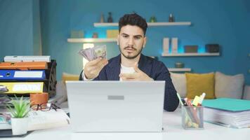 Man with money in hand making video call.