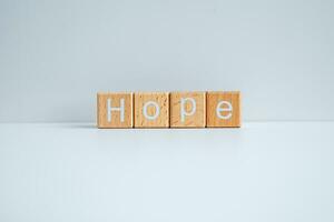 Wooden blocks form the text Hope against a white background. photo