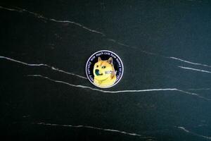 Doge coin DOGE on black marble texture. photo