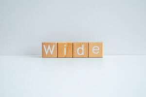 Wooden blocks form the text Wide against a white background. photo