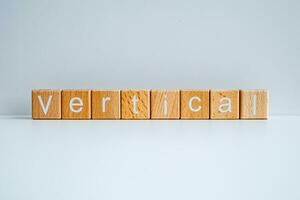 Wooden blocks form the text Vertical against a white background. photo