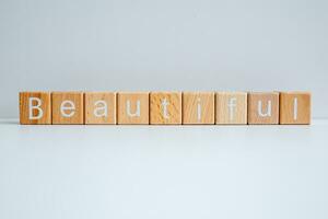 Wooden blocks form the text Beautiful against a white background. photo