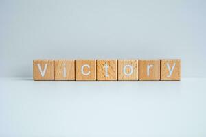 Wooden blocks form the text Victory against a white background. photo