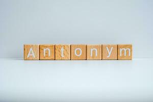 Wooden blocks form the text Antonym against a white background. photo