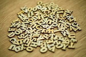 Scattered English letters with wooden background. photo