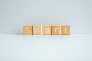 Wooden blocks form the text Short against a white background. photo