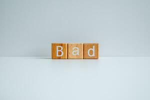 Wooden blocks form the text Bad against a white background. photo
