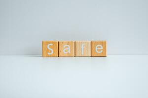 Wooden blocks form the text Safe against a white background. photo