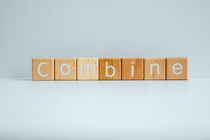 Wooden blocks form the text Combine against a white background. photo