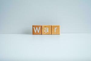 Wooden blocks form the text War against a white background. photo