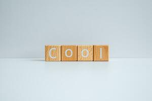 Wooden blocks form the text Cool against a white background. photo