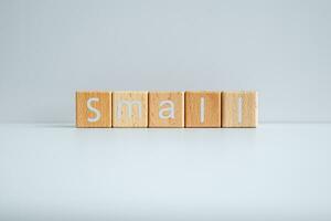 Wooden blocks form the text Small against a white background. photo
