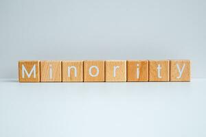 Wooden blocks form the text Minority against a white background. photo