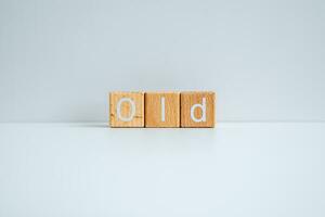 Wooden blocks form the text Old against a white background. photo