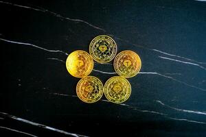 5 Tether coins USDT arranged in a circle on a black marble background. photo