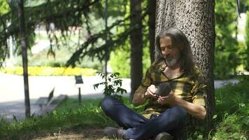 The man with the money is sitting outside and is happy. video