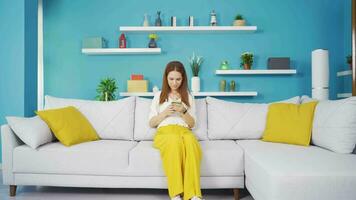 Young woman lying on the sofa is resting. video