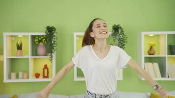 Happy young woman looking around at home with joy and excitement. video