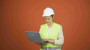 Engineer holding laptop laughing at camera. video