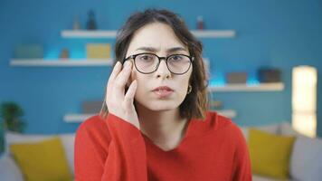 Guilty young woman looking innocently at camera. video