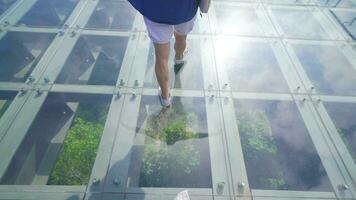 The man in nature walks on the glass terrace. video