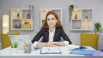 Home office worker woman looking at camera depressed. video