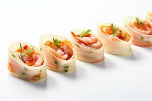 Chefs artistic folding of miniature fingerfood wraps isolated on a white background photo