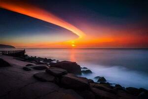 a sunset over the ocean with rocks and a long line of light. AI-Generated photo
