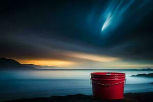 a red bucket sitting on the beach at night. AI-Generated photo