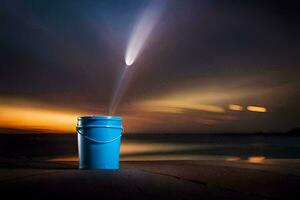 a blue bucket on the beach with a light coming from it. AI-Generated photo