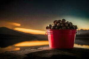 a bucket of nuts on a rock by a lake. AI-Generated photo