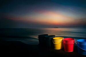 four colorful buckets sit on the beach at sunset. AI-Generated photo