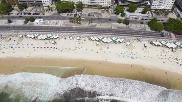 Rio de Janeiro City on Sunny Day. Copacabana Beach and Atlantic Ocean. Avenida Atlantica. Aerial Hyper Lapse, Time Lapse. Brazil. Drone Flies Sideways. High Angle Shot video