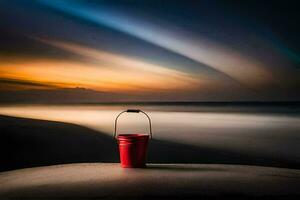 un rojo Cubeta se sienta en el borde de un playa a puesta de sol. generado por ai foto