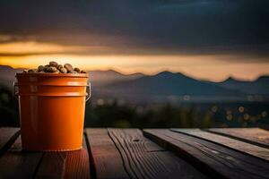 a bucket of nuts on a wooden table with mountains in the background. AI-Generated photo